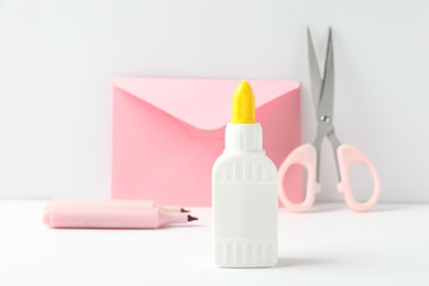 Photo of Glue and other stationery on white table