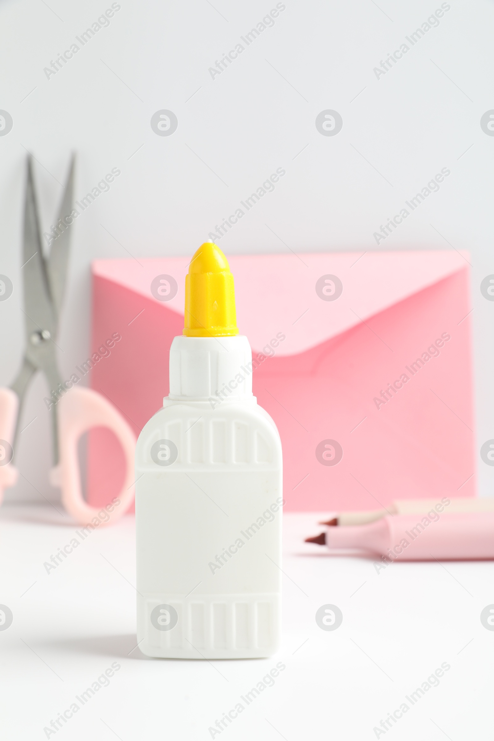 Photo of Glue and other stationery on white table