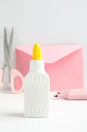 Photo of Glue and other stationery on white table