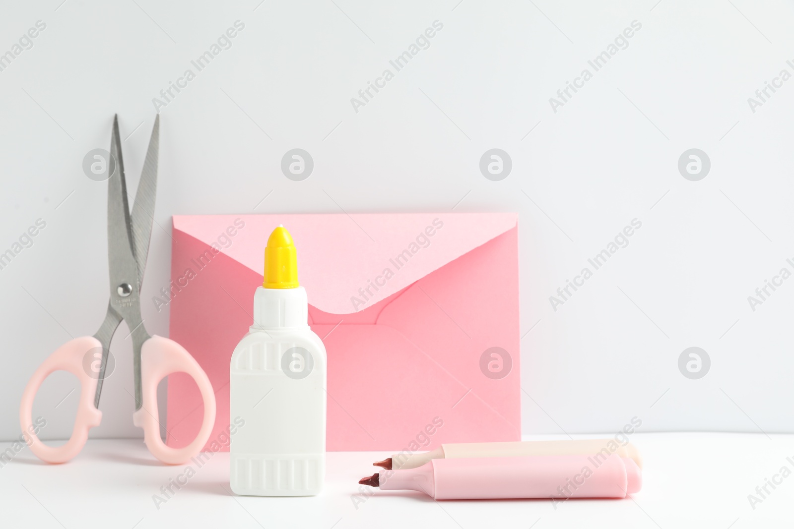 Photo of Glue and other stationery on white table