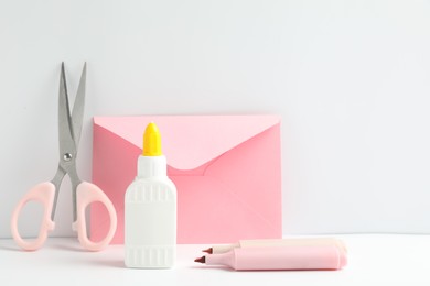 Photo of Glue and other stationery on white table