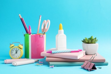 Photo of Glue and other stationery on light blue background
