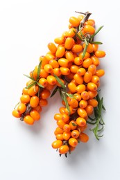 Photo of Branches with ripe sea buckthorn berries and leaves on white background, top view