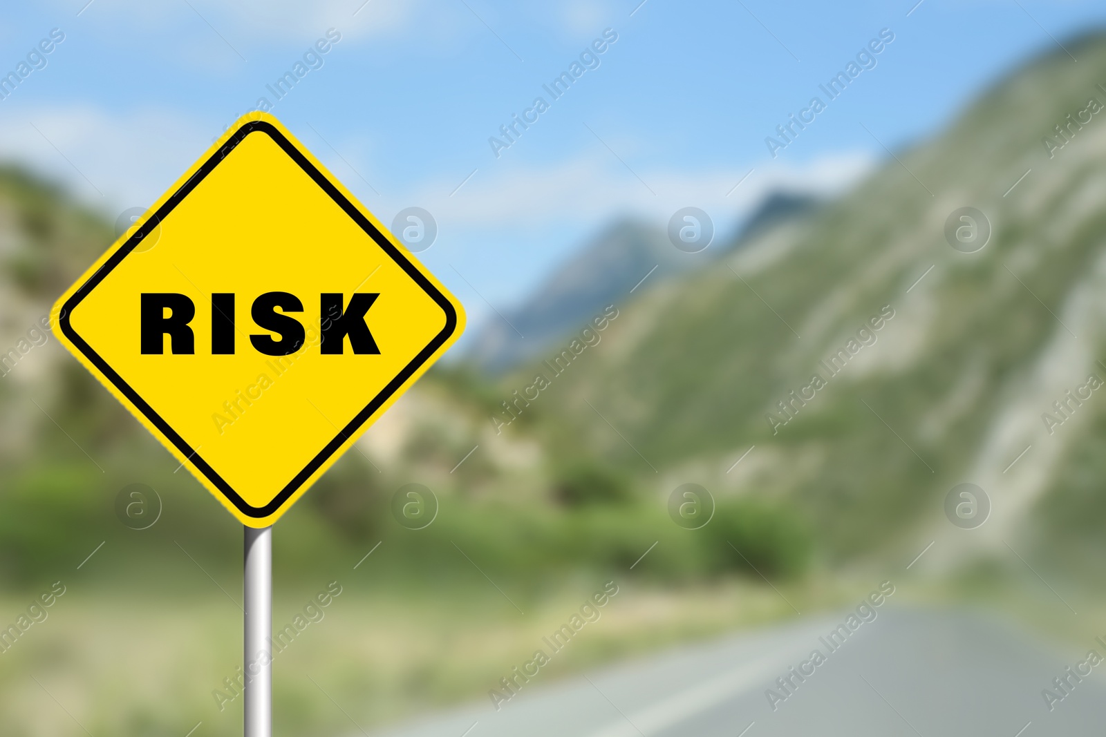 Image of Yellow road sign with word Risk on highway, closeup