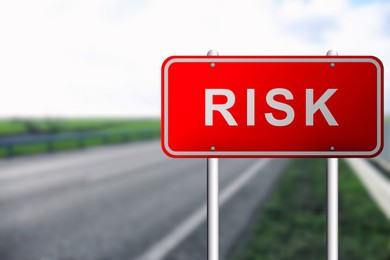 Image of Red road sign with word Risk outdoors