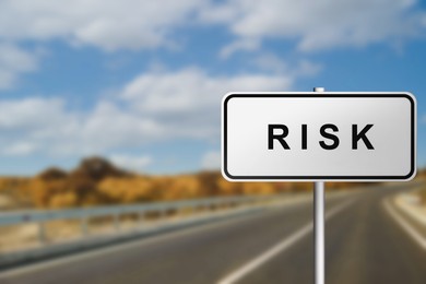 Image of Road sign with word Risk outdoors, closeup