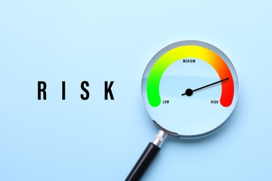 Image of Risk word and magnifying glass with scale inside on light blue background, top view