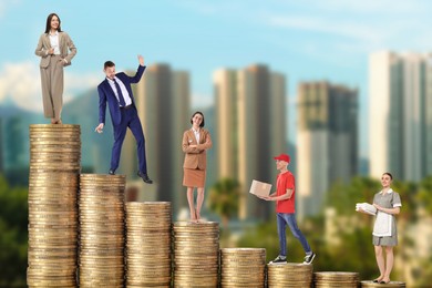 Image of People of various professions standing on different stacks of coins according to their salaries against blurred cityscape. Concept of rich, wealth