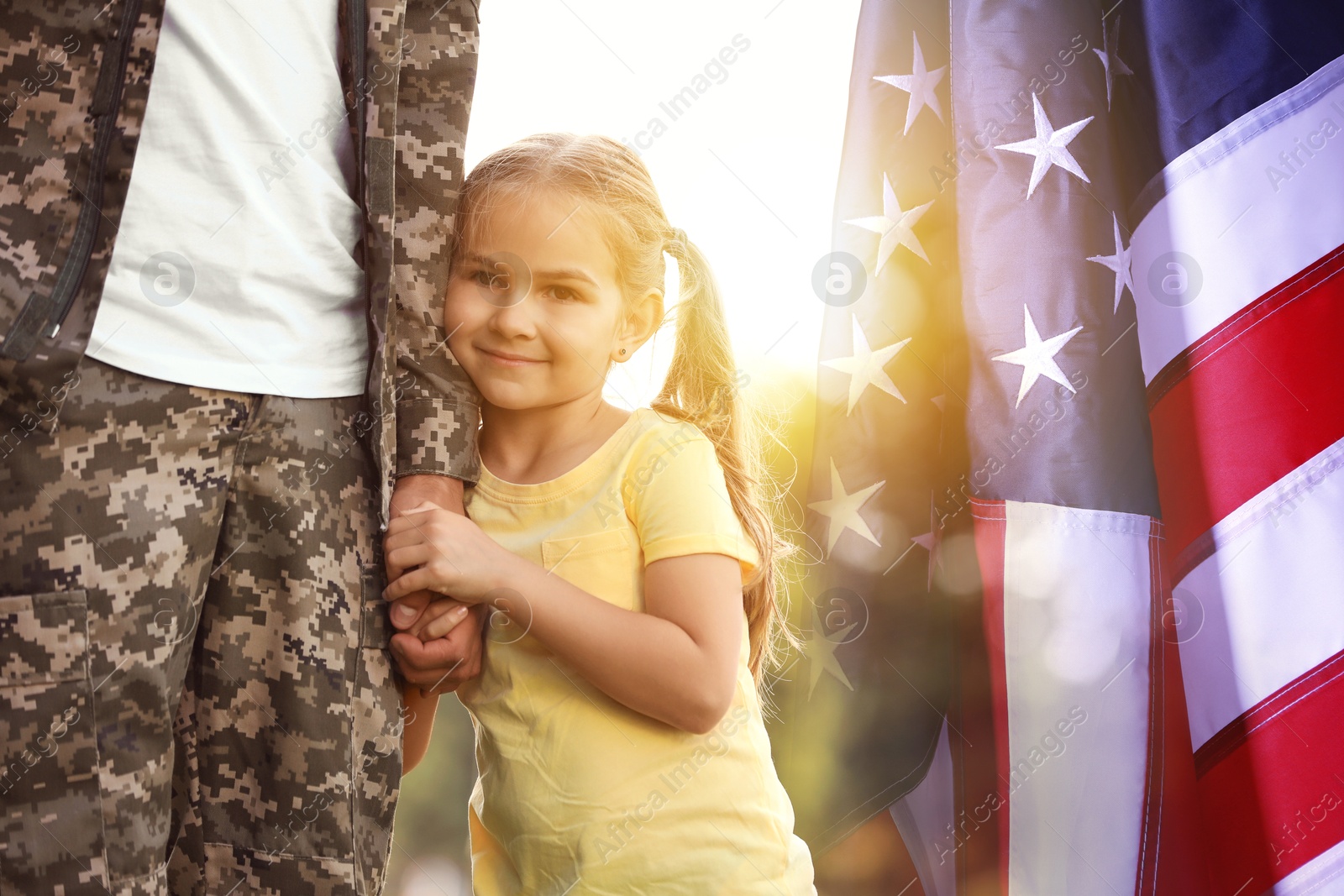 Image of Military man and his daughter outdoors, double exposure with national flag of USA