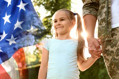 Image of Military man and his daughter outdoors, double exposure with national flag of USA