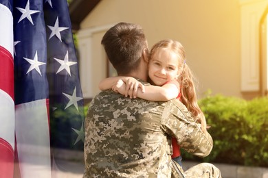 Image of Military man and his daughter outdoors, double exposure with national flag of USA