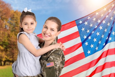 Image of Military woman and her daughter outdoors against national flag of USA
