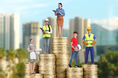Image of People of various professions standing on different stacks of coins according to their salaries against blurred cityscape. Concept of rich, wealth