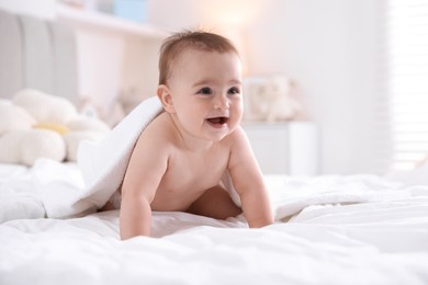 Photo of Cute baby with white towel after bathing on bed at home, space for text