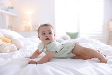 Photo of Cute little baby on bed at home