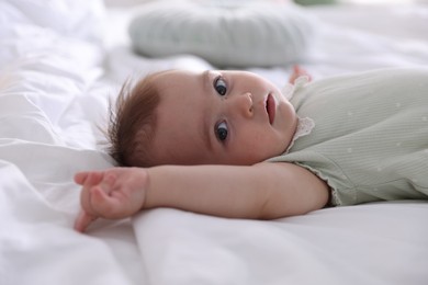 Photo of Cute little baby on bed at home