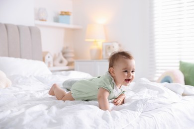 Photo of Cute little baby on bed at home