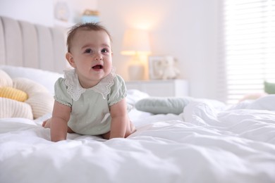 Photo of Cute little baby on bed at home, space for text