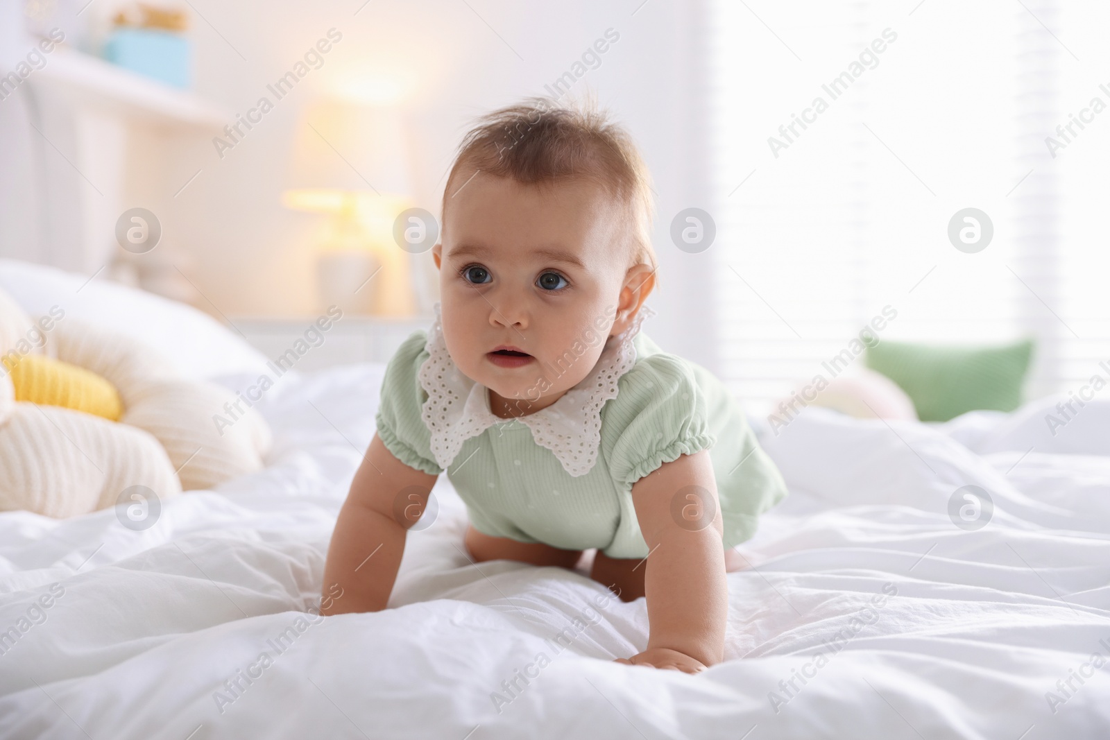 Photo of Cute little baby on bed at home