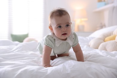 Photo of Cute little baby on bed at home