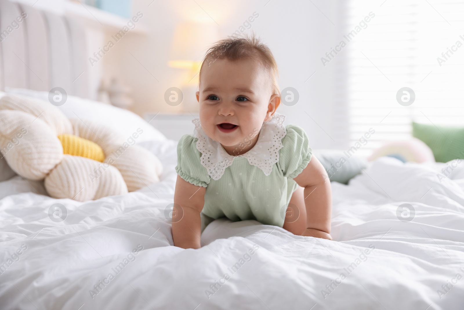 Photo of Cute little baby on bed at home