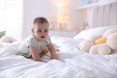 Photo of Cute little baby on bed at home, space for text