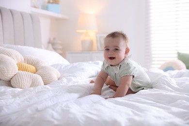 Photo of Cute little baby on bed at home, space for text