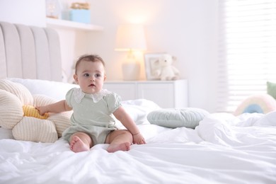Photo of Cute little baby on bed at home, space for text