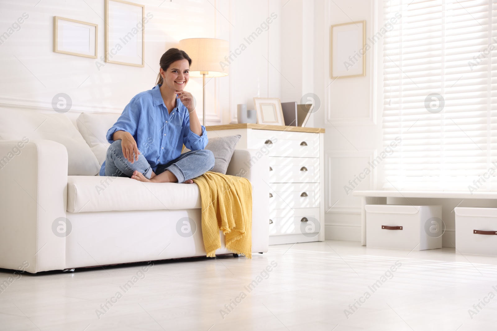Photo of Positive woman on sofa at home. Space for text