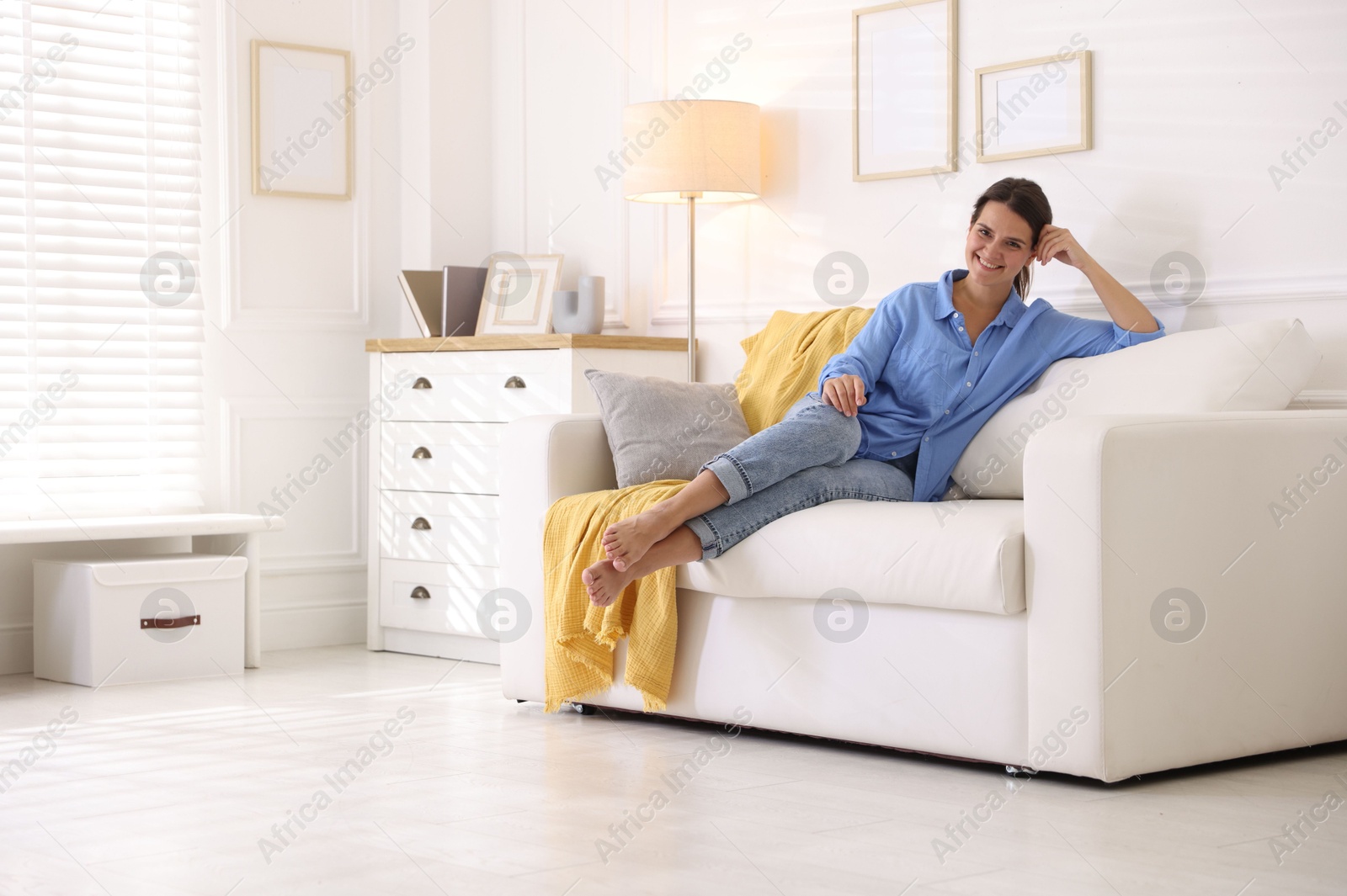 Photo of Positive woman on sofa at home. Space for text