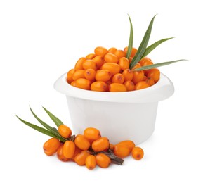 Photo of Fresh sea buckthorn berries with green leaves isolated on white