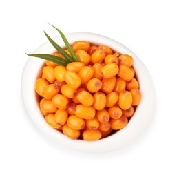 Photo of Fresh sea buckthorn berries with green leaves in bowl isolated on white, top view