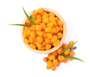 Photo of Fresh sea buckthorn berries with green leaves isolated on white, top view