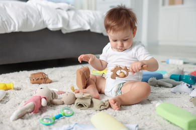 Photo of Cute baby and different accessories on floor