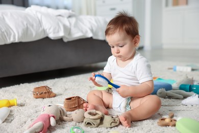 Photo of Cute baby and different accessories on floor