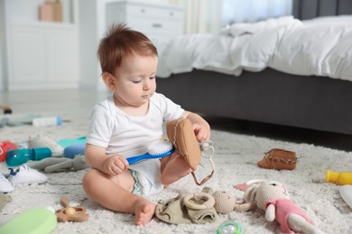 Photo of Cute baby and different accessories on floor