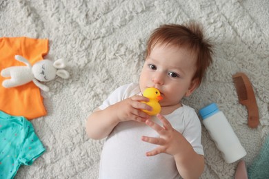 Photo of Cute baby, different clothes and accessories on floor, top view