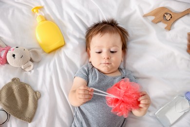 Photo of Cute baby and different accessories on bed, top view
