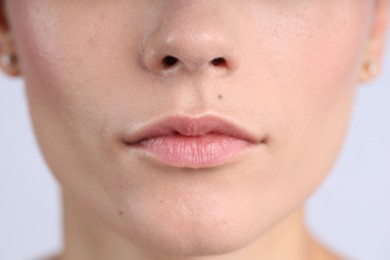Photo of Woman with normal skin on light background, closeup