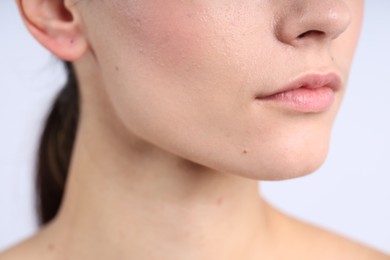 Photo of Woman with normal skin on light background, closeup