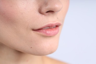 Photo of Woman with normal skin on light background, closeup. Space for text