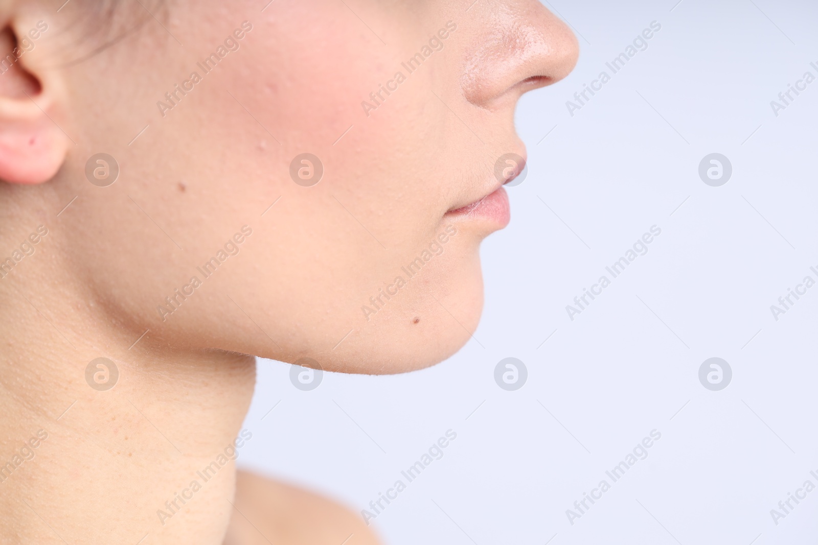 Photo of Woman with normal skin on light background, closeup. Space for text