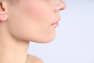 Photo of Woman with normal skin on light background, closeup. Space for text