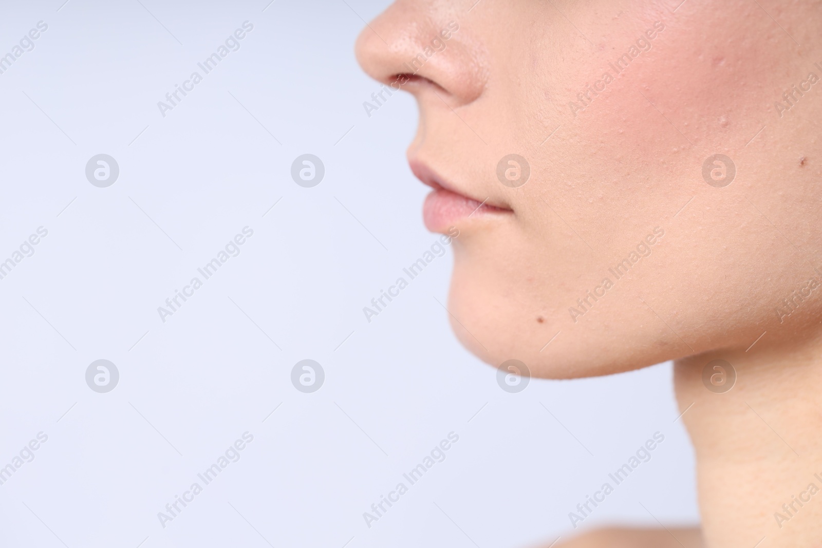 Photo of Woman with normal skin on light background, closeup. Space for text