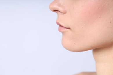 Photo of Woman with normal skin on light background, closeup. Space for text