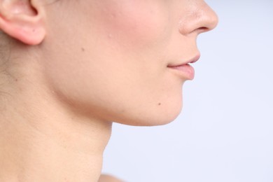 Photo of Woman with normal skin on light background, closeup. Space for text