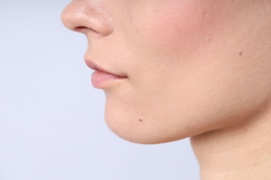 Photo of Woman with normal skin on light background, closeup. Space for text
