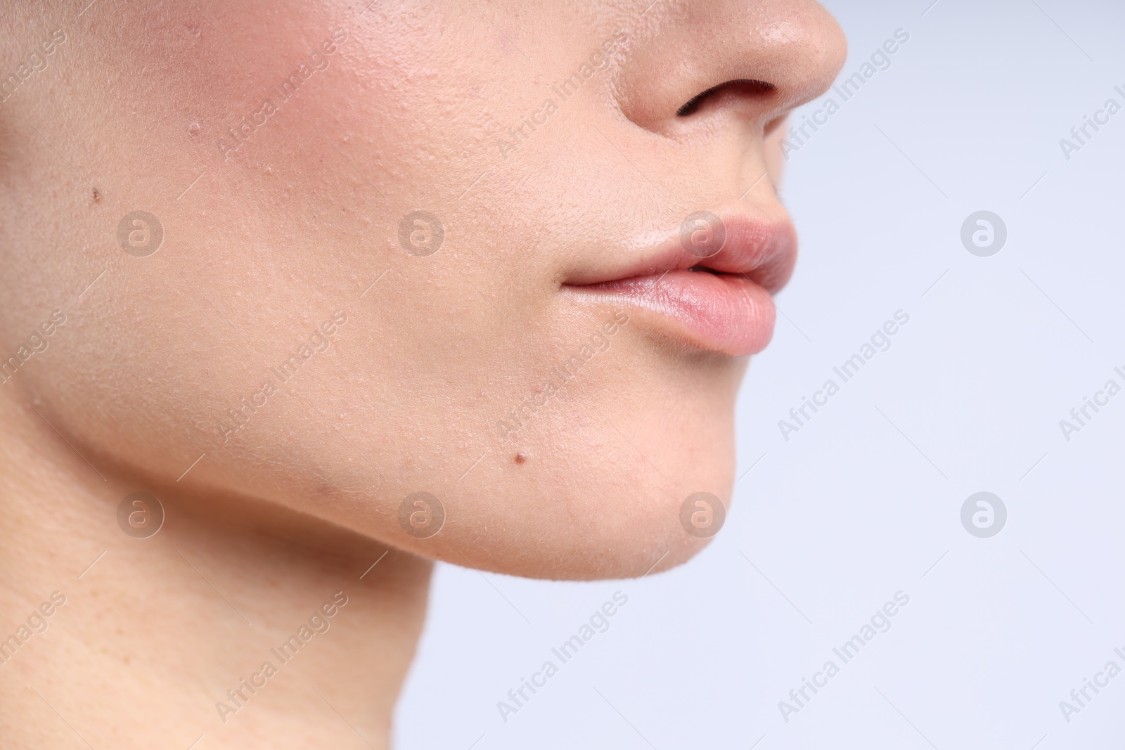 Photo of Woman with normal skin on light background, closeup. Space for text