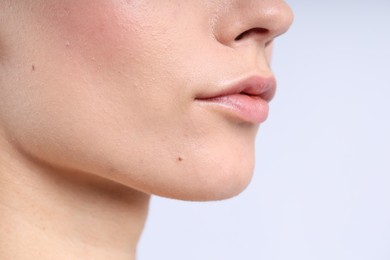 Photo of Woman with normal skin on light background, closeup. Space for text