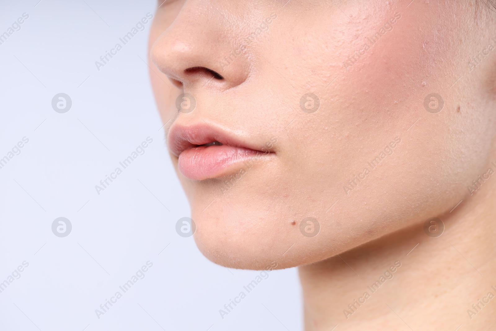 Photo of Woman with normal skin on light background, closeup. Space for text